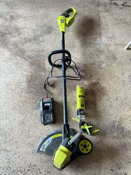 RYOBI 18V battery powered weed eater with accessories and charger image