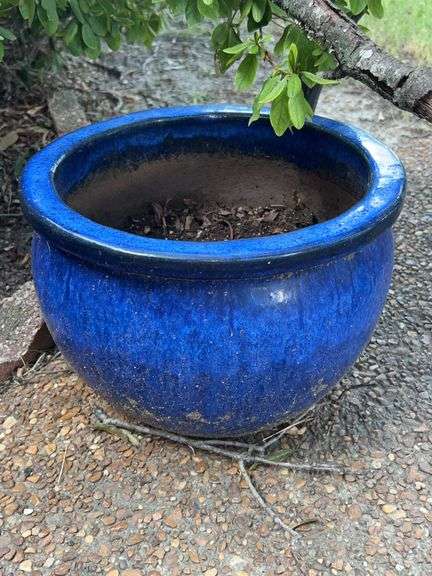Assorted sizes and color planters and yard statues and stones image