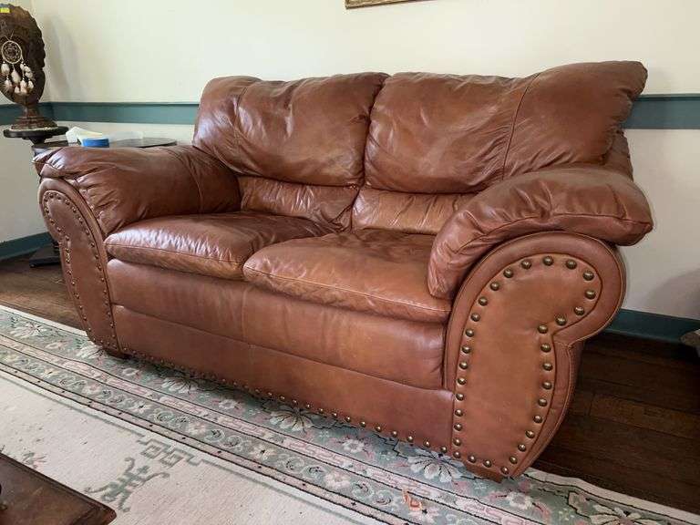 Faux leather camel color scroll arm loveseat with brass studs…..69 x 22-1/2 x 36 tall overall image