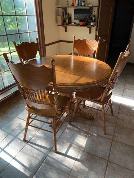 Solid oak farmhouse style pedestal ball and claw table with 5 carved back chairs…..table measures ￼49-1/2”D x 31” tall…..each chair is 17-3/4 x 17-1/4 x 42-1/2 tall…..shows wear from normal use but lots of life left image