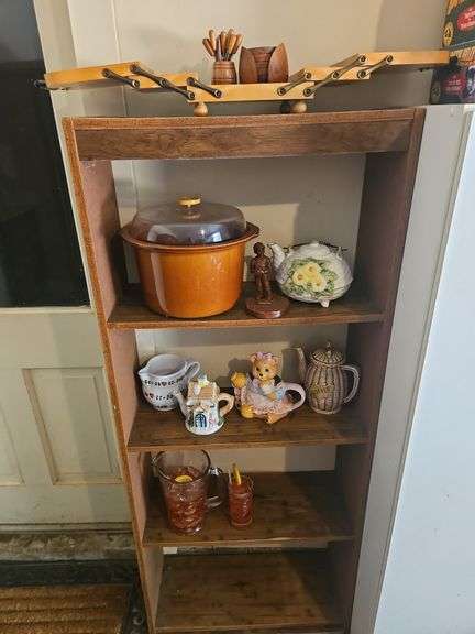 Collection of ceramic teapots and other items on bookshelf INCLUDES BOOKSHELF 24x9x59... image