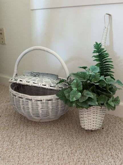Lidded white wicker basket and small hanging white basket with artificial greenery image