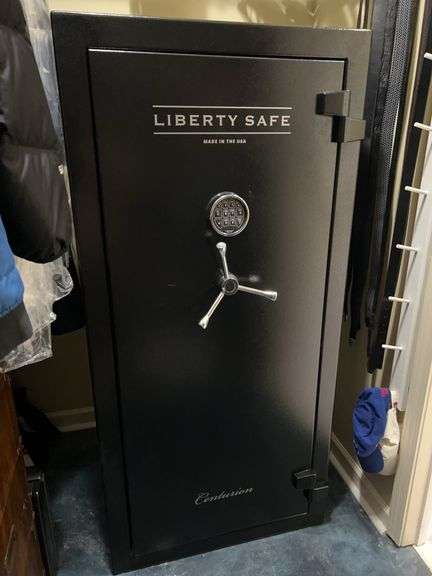 Liberty Safe Centurion series gun safe…..immaculate condition…..shelf on right is removable so that it can hold more guns…..28-1/4 x 20-1/4 x 59-1/4…..BUYER MUST BRING HELP FOR CAREFUL REMOVAL AND TRANSPORT image
