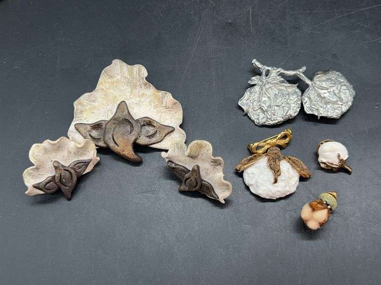 Grouping of cotton boll jewelry…..3-piece set far right, heavy silver-toned brooch, 2 lapel pins and brooch with gold-tone bow closure image