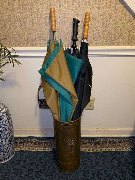 Brass umbrella stand with umbrellas image