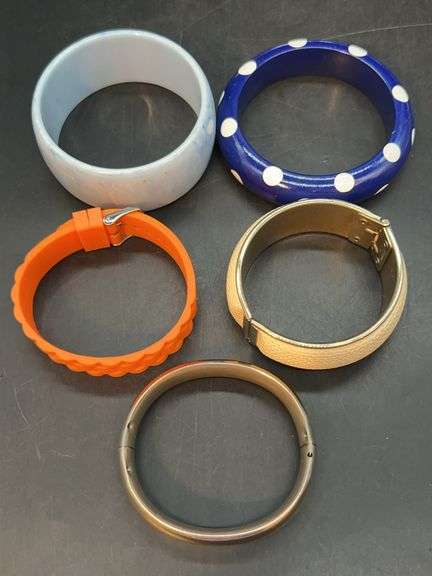 Hinged bracelets, bangles and an orange neoprene bracelet…..ivory colored is vintage Sarah Coventry image