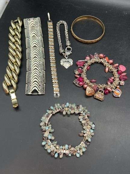 Nice grouping of bracelets…..charm, stretchy, bangle, Nana charm bracelet and clasp bracelets image