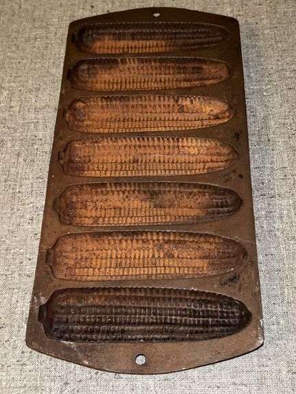 7-slot cast iron corn muffin pan……needs cleaned and seasoned…..marked R on one back handle and 2 on the other image