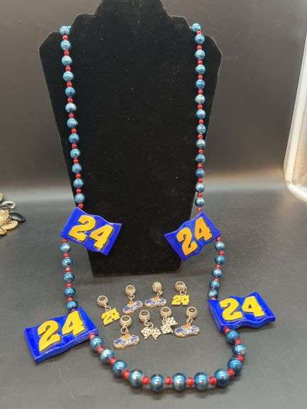 Collection of Jeff Gordon jewelry items…..Marti Gras style beads and several charms image