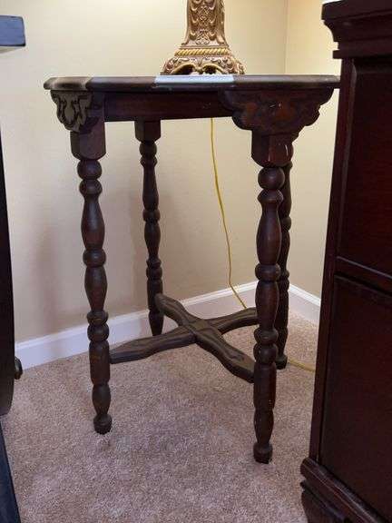 Vintage scalloped edge table with carved top and supports at bottom…..22”D x 27-1/2” tall image