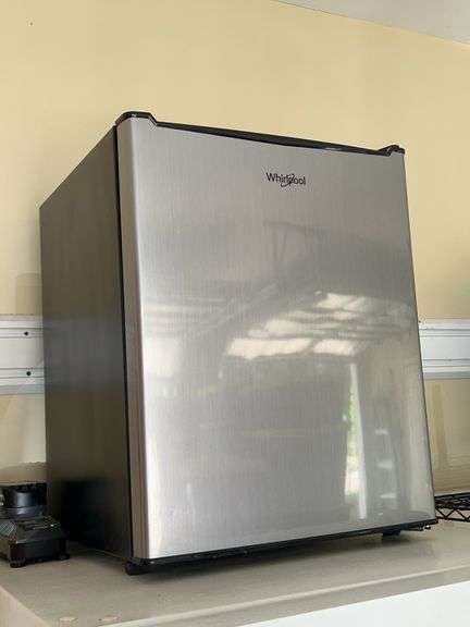 Whirlpool dorm size refrigerator with stainless front…..has slight blemish bottom front image