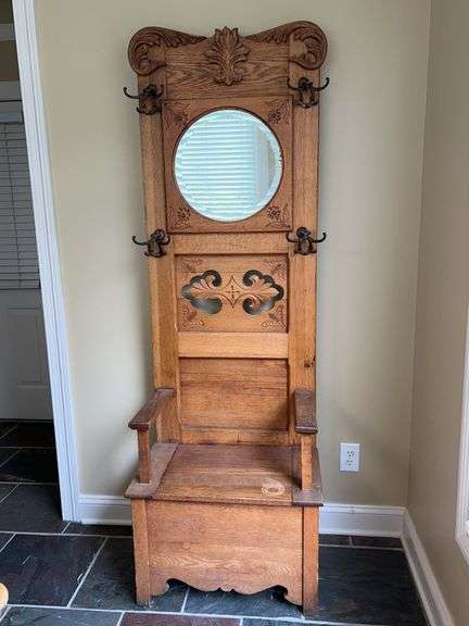 Antique oak hall tree with round beveled mirror and nice carving…..26 x 17 x 17-1/4 to seat (7$ tall overall)…..has blemishes but for its age, overall good condition…..heavy piece image