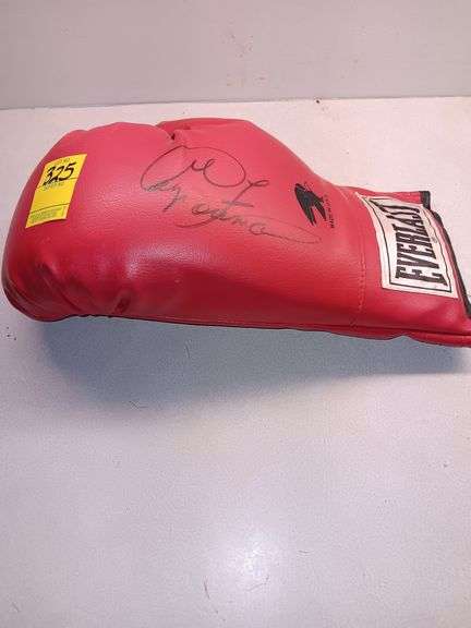 Signed Boxing Glove by George Foreman.. Newspaper shows when purchased at Auction image