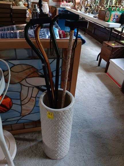 White umbrella stand with crazen and four canes image