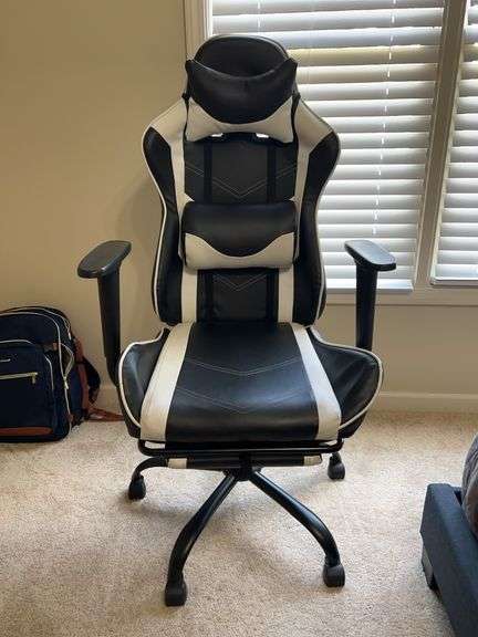 Black & White leather swivel gaming chair with pull out foot rest…..in really good condition…..25 x 29 x 21 to seat (50 tall overall) image