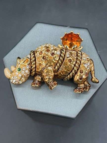 Gorgeous St. John Rhino brooch with clear, green and amber colored stones image