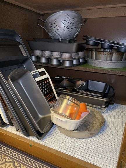 Contents of kitchen cabinet…..glass casserole dishes, baking pans and more image