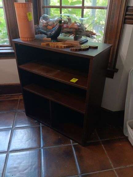 Brown shelf. 28 1/2 x 25 1/2 x 12.. Contents on top not included image