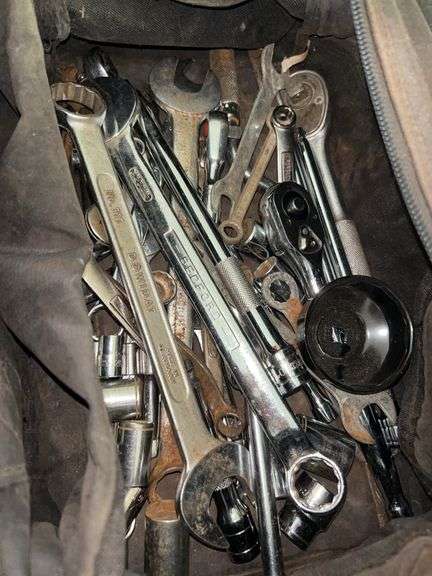 Canvas bag full of wrenches and sockets in various sizes image