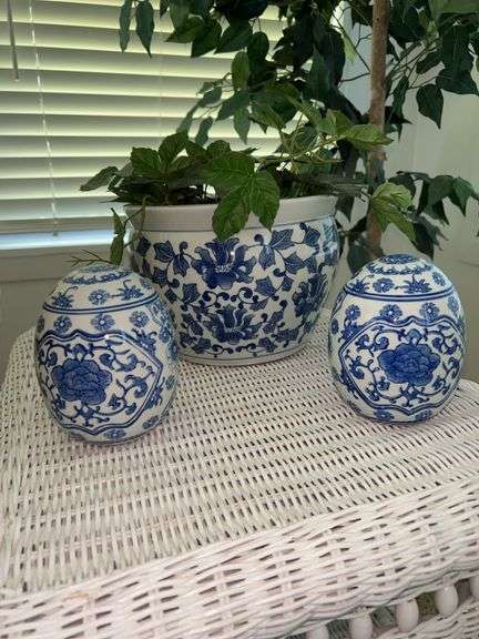 Blue and white planter with artificial greenery and (2) egg shaped home decor pieces image