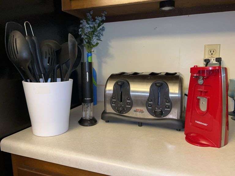 Grouping of kitchen items…..Red Farberware electric can opener, Aroma Prestige 4-slice toaster (needs cleaned), Brookstone battery powered wine bottle opener and white ceramic vase with black plastic kitchen utensils image