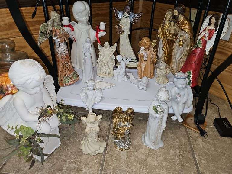 Grouping of angels cherubs and Nativity figurines. Sizes range from 2 in tall to 13 in tall. Baker's rack is not included.