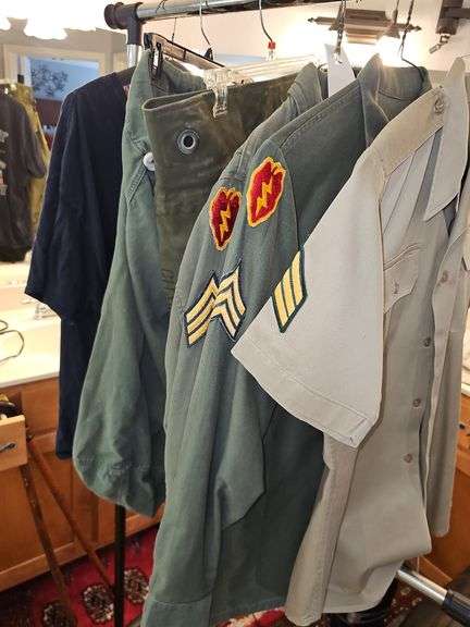 Vintage military items. Include shirts duffel bags and a Vietnam veteran t-shirt.