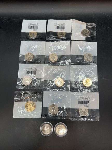 Grouping of various uncirculated coins…..(1) gold plated Sacagawea Dollar, Gold Plated Statehood Quarter and several silver tone statehood quarters image
