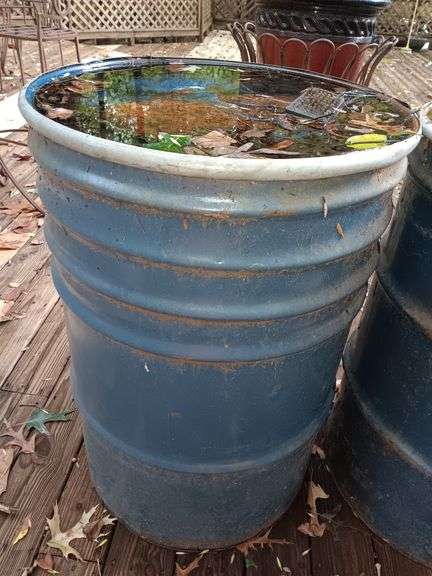 Empty blue metal barrel 35 inches by 24 inches.