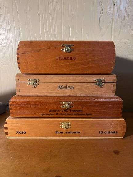 Very nice selection of wooden cigar boxes….one still has original broken seal image