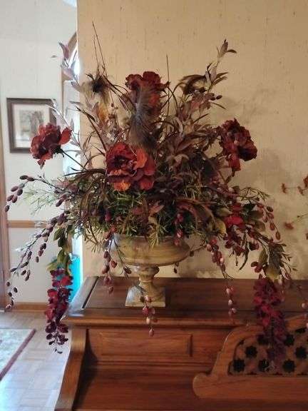Great looking artificial florals centerpiece in resin urn planter image
