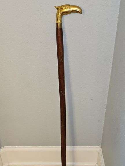 36-in tall brass eagle head cane with brass inlay throughout stick.