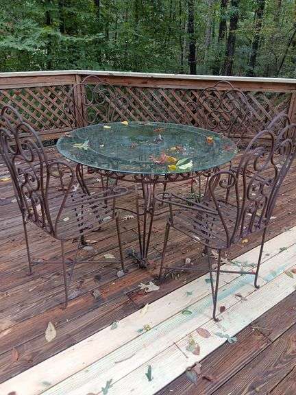 Rod Iron Table with 4 arm chairs and glass top 30 x 48.