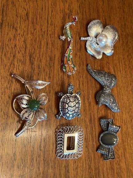 Elegant grouping of silver toned brooches image