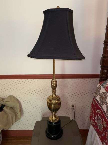 Beautiful brass trophy-style base lamp with black cloth shade and 3-way switch…..36-3/4” tall….needs new harp to better center shade image