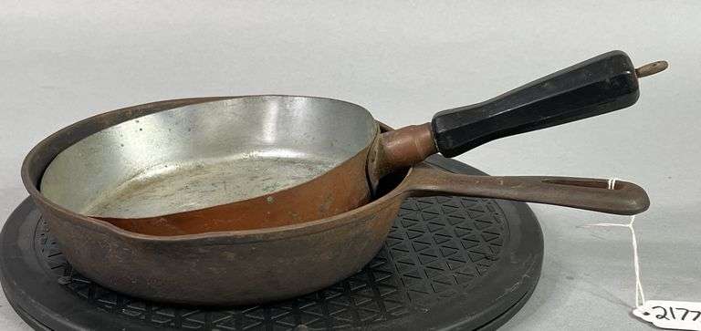 Solid Copper Skillet and Unmarked Cast Iron Skillet. image