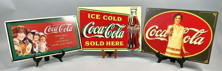 Three Coca-Cola Advertising Signs image