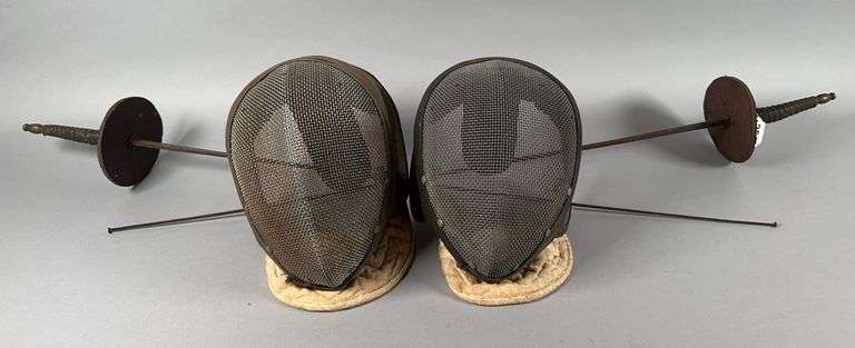 A Pair of Fencing Masks and Swords image