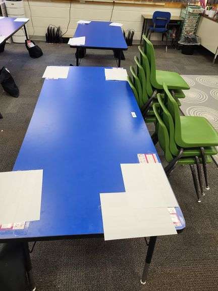 2 blue school tables and 8 green stacking chairs image