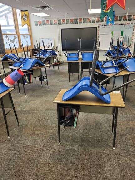 15 school desks, 14 blue stacking chairs- items on and around desks not included image