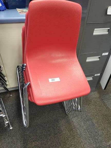 Stack of 9 red school chairs image