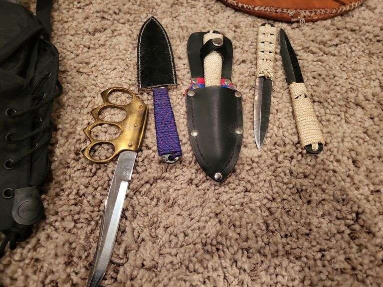 Brass knuckle knife,
Metal/ leather shield, throwing knives, pack