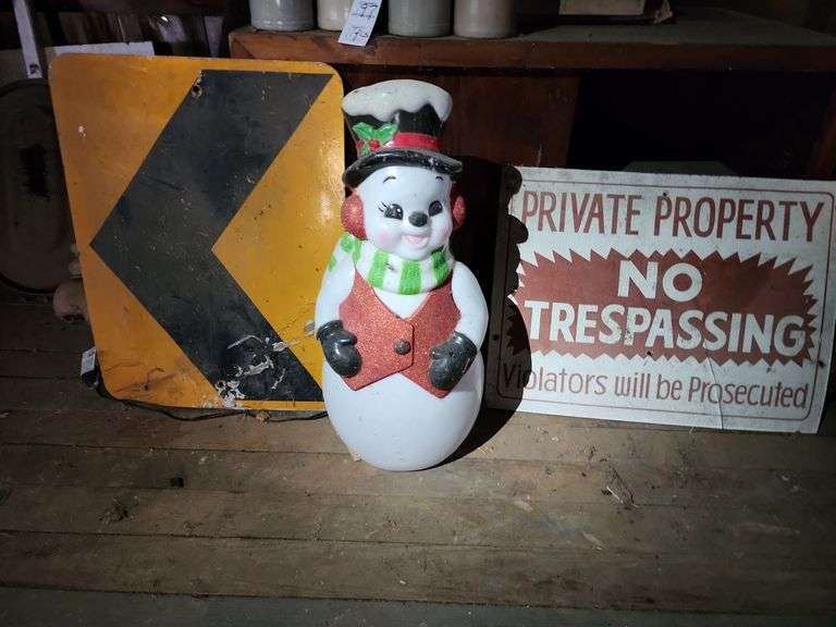 Snowman Decor, No Trespassing Sign, and Roadway Arrow Sign image