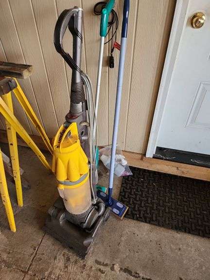 Dyson and 2 Swiffer Mops image