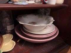 Contents of Lower Cabinet - serving bowls, plates, cups, misc