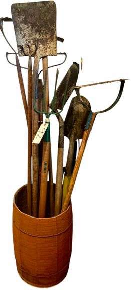 WOODEN BARREL W/ ASSORTMENT OF YARD TOOLS: SQUARE SHOVEL, SPADE SHOVEL, RAKE, HAY FORK, ETC. image
