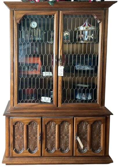 LARGE LIGHTED CHINA CABINET FEATURING METALWORK OVER THE GLASS DOORS - HAS PECAN FINISH OVER DARK OAK image