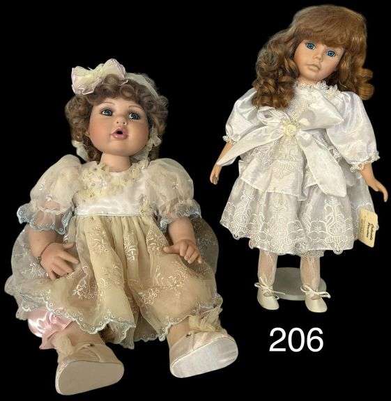TWO DOLLS: COLLECTIBLE PORCELAIN BY SHOWSTOPPERS ON STAND - APP. 17.5 INCHES TALL, OTHER DOLL IS A LARGER MARIE OSMOND DOLL NUMBERED 0381/1500, PORCELAIN FACE, HANDS AND FEET - APP. 14 INCHES TALL IN SITTING POSITION (14 INCHES NOT INCLUDING LEGS) image