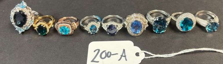 9 STERLING SILVER RINGS W/ AQUA BLUE AND SAPPHIRE TYPE STONES - 34.23 GRAMS, 1.10 TROY OZ - SIZES 5-7 image