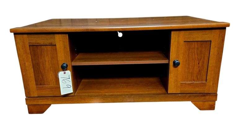 WOODEN ENTERTAINMENT STAND W/ 2 DOORS AND 2 SHELVES APPROX. 42” WIDE X 19.75” TALL X 21.25” DEEP - SOME SCRATCHING ON TOP image